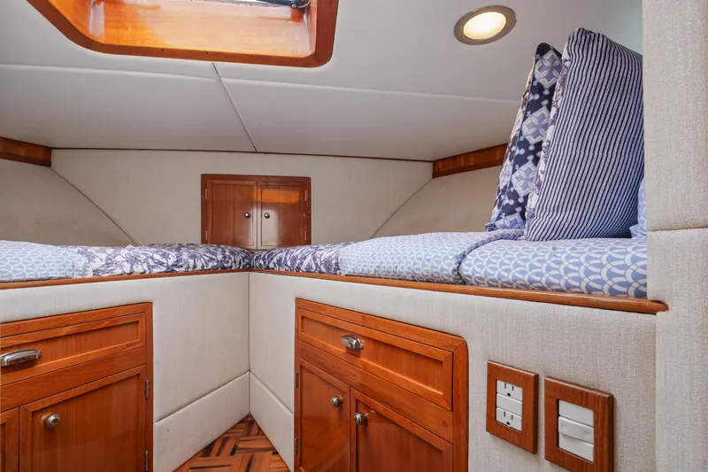 Slide: The Image of 1970 Hargrave Yachtfisher cabin interior with wooden cabinets and patterned bedding. - 53