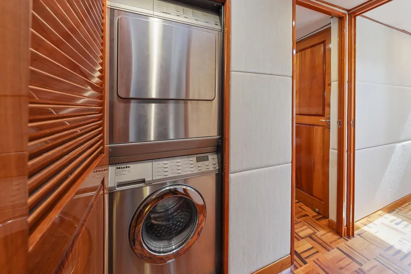 Slide: The Image of Stacked washer and dryer in 1970 Hargrave Yachtfisher interior with wood paneling. - 54