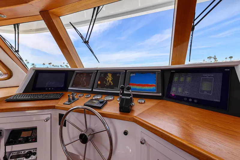 Slide: The Image of Cockpit of 1970 Hargrave Yachtfisher with modern navigation equipment and wooden accents. - 57