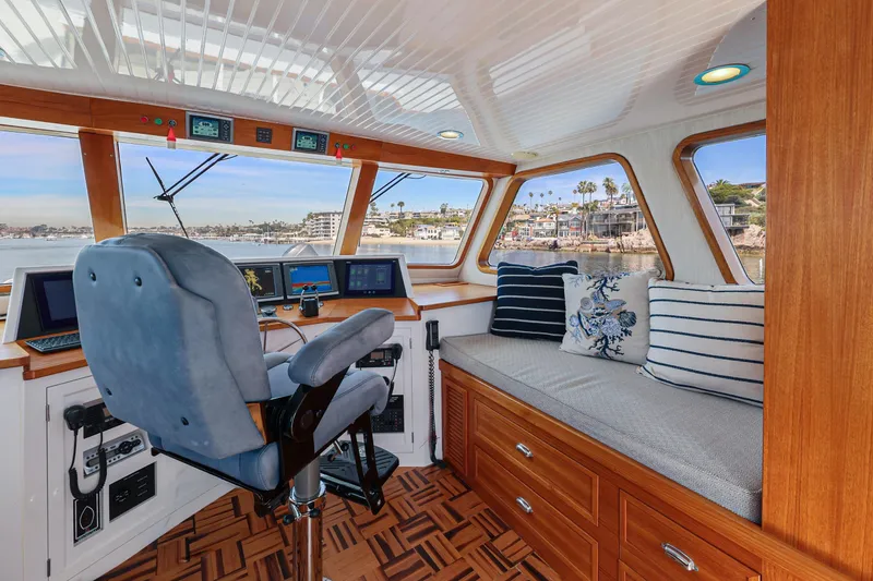 Slide: The Image of 1970 Hargrave Yachtfisher helm with plush seating, nautical decor, and panoramic windows. - 58