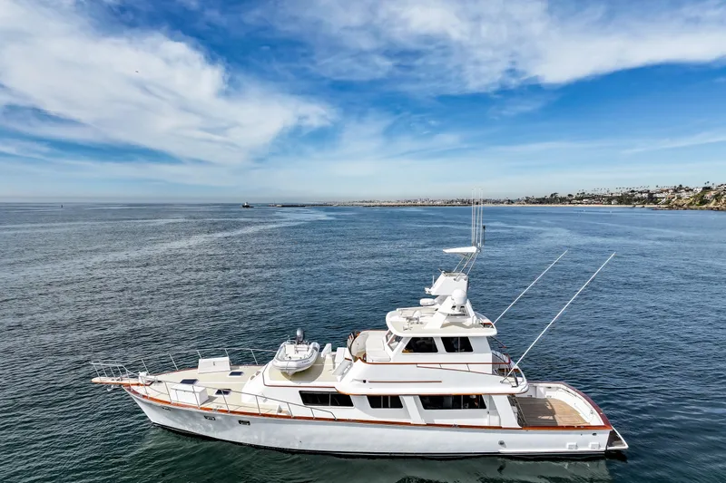 Slide: The Image of 1970 Hargrave Yachtfisher cruising on open sea under clear blue sky. - 6