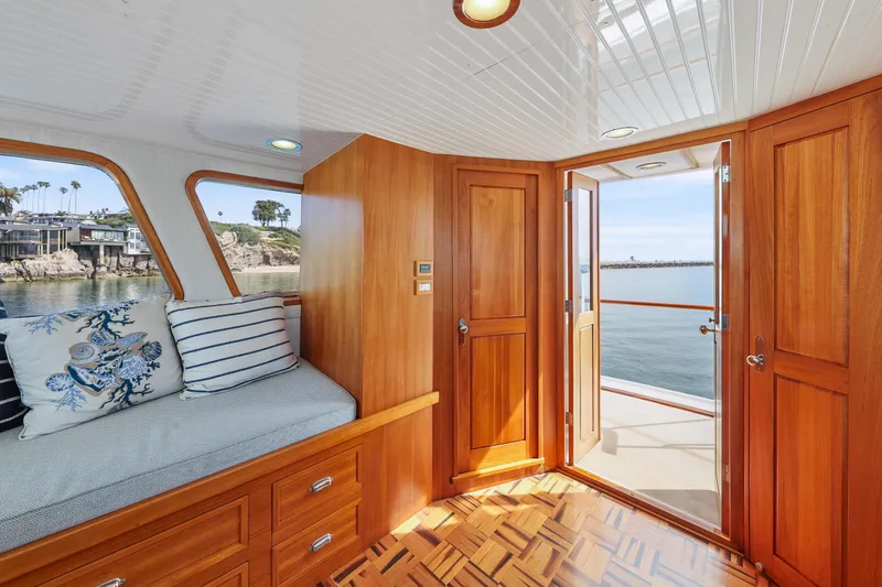Slide: The Image of Interior of 1970 Hargrave Yachtfisher with wooden finish, cozy seating, and ocean view. - 61