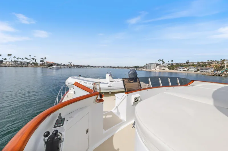 Slide: The Image of 1970 Hargrave Yachtfisher cruising in a scenic coastal area with clear blue skies. - 62