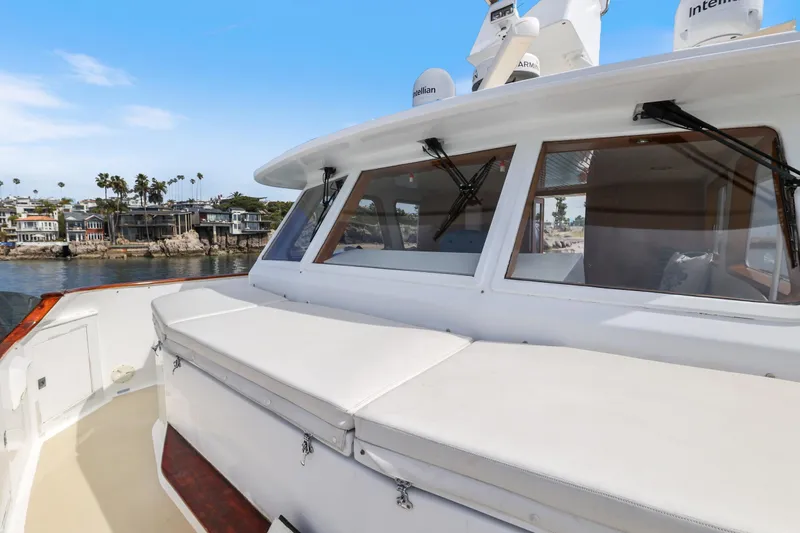 Slide: The Image of 1970 Hargrave Yachtfisher with spacious deck, docked near waterfront homes. - 63