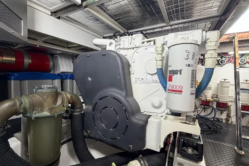 Slide: The Image of Engine room of a 1970 Hargrave Yachtfisher, featuring mechanical components and filters. - 75