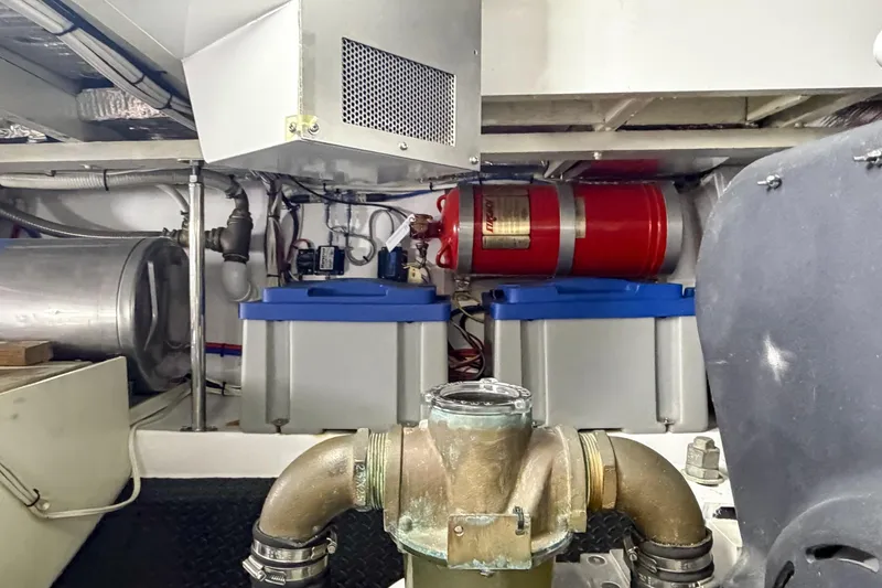 Slide: The Image of Engine room of a 1970 Hargrave Yachtfisher, featuring mechanical components and storage tanks. - 77