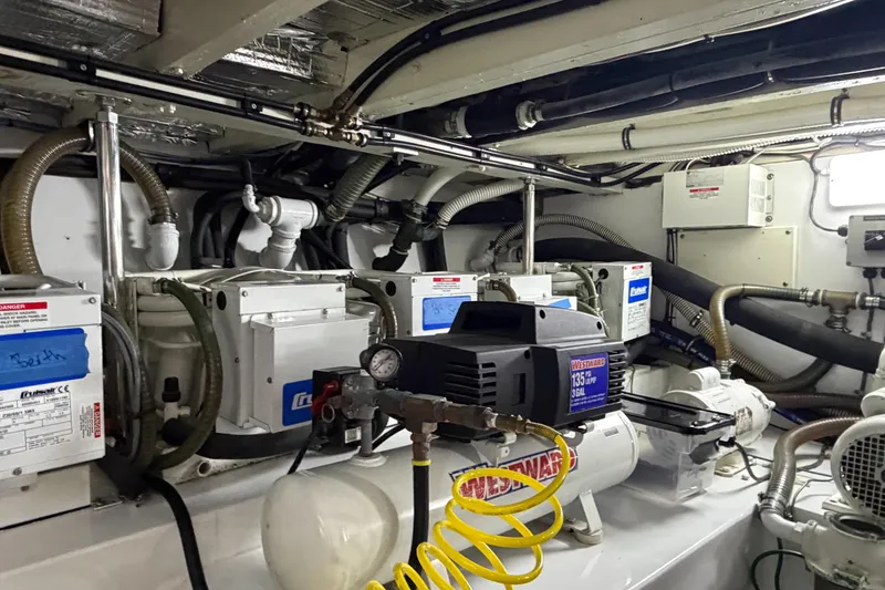 Slide: The Image of Engine room of a 1970 Hargrave Yachtfisher, showcasing mechanical equipment and piping. - 79