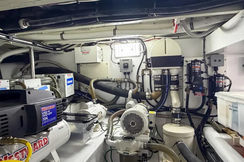 Slide: The Image of Engine room of a 1970 Hargrave Yachtfisher, showcasing mechanical equipment and piping systems. - 80