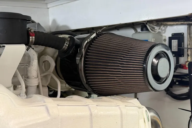 Slide: The Image of Engine compartment of a 1970 Hargrave Yachtfisher, featuring a prominent air filter. - 84