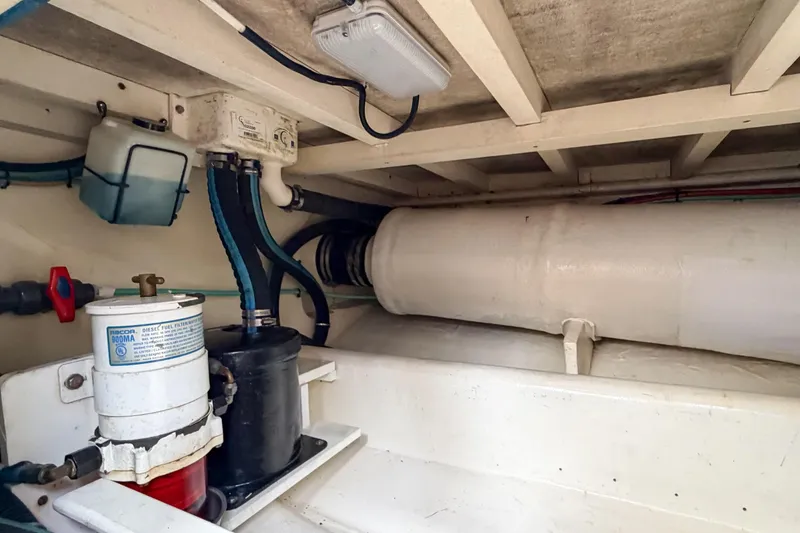 Slide: The Image of Engine room of a 1970 Hargrave Yachtfisher, showcasing fuel filtration system and piping. - 85