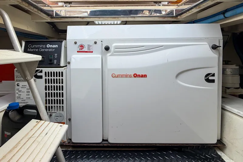 Slide: The Image of Cummins Onan marine generator inside 1970 Hargrave Yachtfisher, showcasing engine room details. - 87