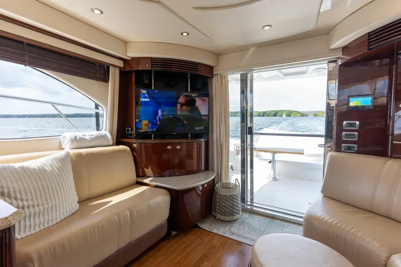 Slide: The Image of Luxurious interior of 2008 Sea Ray 520 Sedan Bridge yacht with TV and lake view. - 15