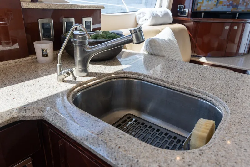 Slide: The Image of Luxury kitchen sink on 2008 Sea Ray 520 Sedan Bridge yacht, featuring modern fixtures. - 18