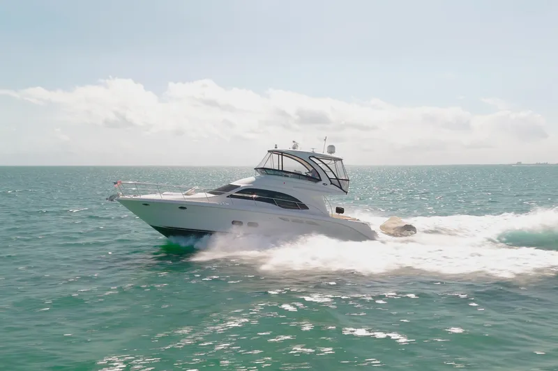 Slide: The Image of 2008 Sea Ray 520 Sedan Bridge yacht cruising on open water. - 2