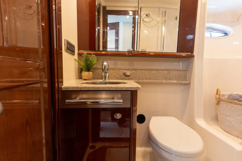 Slide: The Image of Luxurious bathroom interior of 2008 Sea Ray 520 Sedan Bridge yacht, featuring elegant wood and granite finishes. - 28