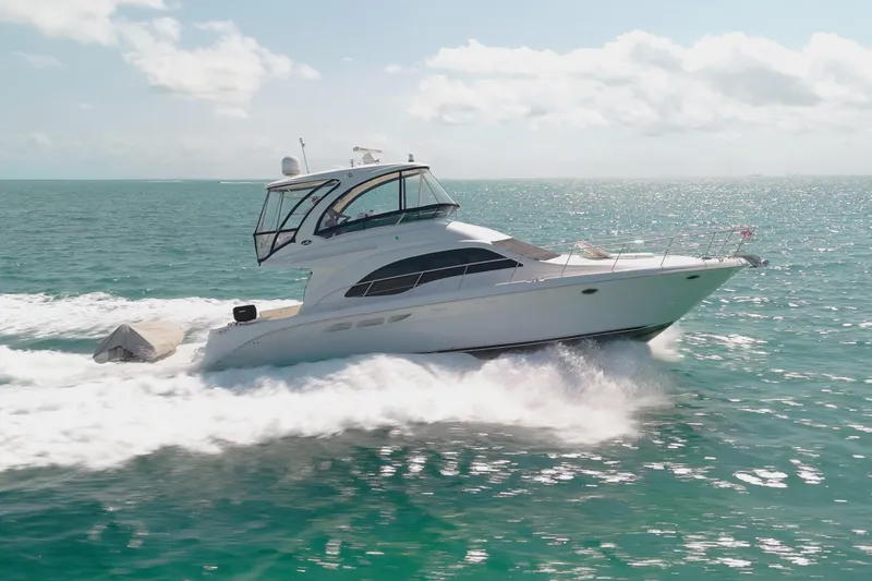 Slide: The Image of 2008 Sea Ray 520 Sedan Bridge yacht cruising on open water. - 5