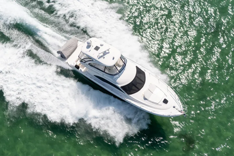 Slide: The Image of 2008 Sea Ray 520 Sedan Bridge yacht cruising on open water, aerial view. - 9