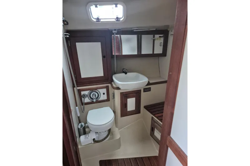 Slide: The Image of 1988 36 Catalina MK I yacht bathroom with sink, toilet, and wooden accents. - 10