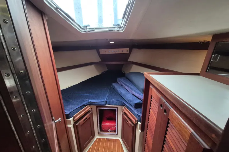 Slide: The Image of 1988 36 Catalina MK I yacht interior with cozy wooden cabin and blue bedding. - 11