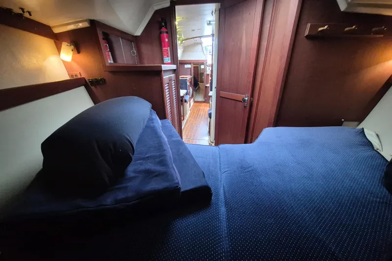 Slide: The Image of Interior cabin of 1988 36 Catalina MK I yacht with cozy bedding and wooden finishes. - 12