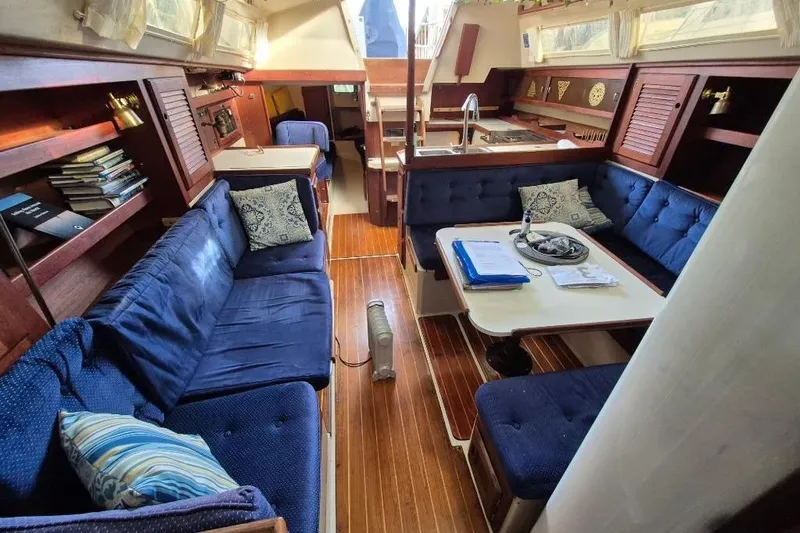 Slide: The Image of Interior of 1988 36 Catalina MK I yacht with blue seating and wooden accents. - 13