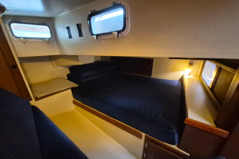 Slide: The Image of 1988 36 Catalina MK I cabin interior with cozy sleeping area and porthole windows. - 15