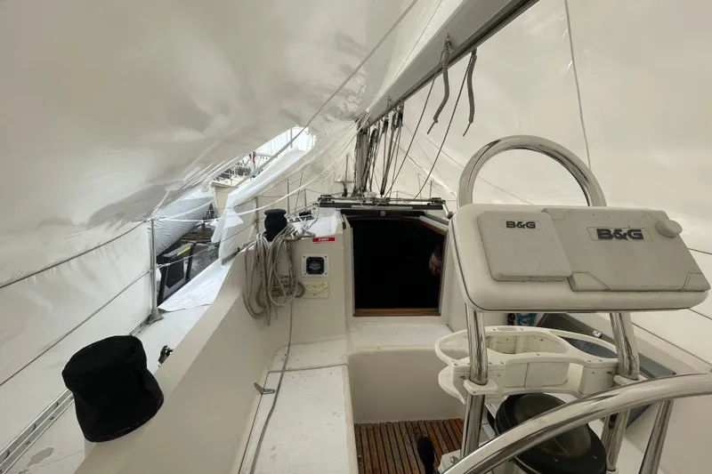 Slide: The Image of 1985 Canadian Sailcraft CS 30 sailboat cockpit with navigation equipment and white canopy. - 10