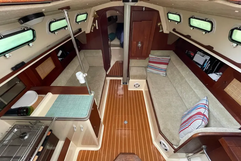 Slide: The Image of 1985 Canadian Sailcraft CS 30 yacht interior with cozy seating and compact kitchen area. - 16