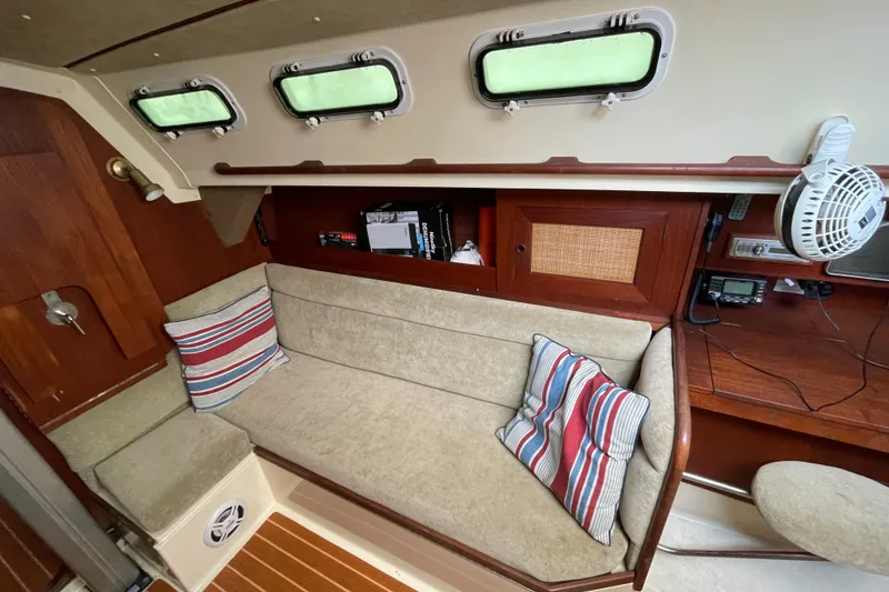 Slide: The Image of Cozy interior of 1985 Canadian Sailcraft CS 30 sailboat with striped cushions and wooden accents. - 18