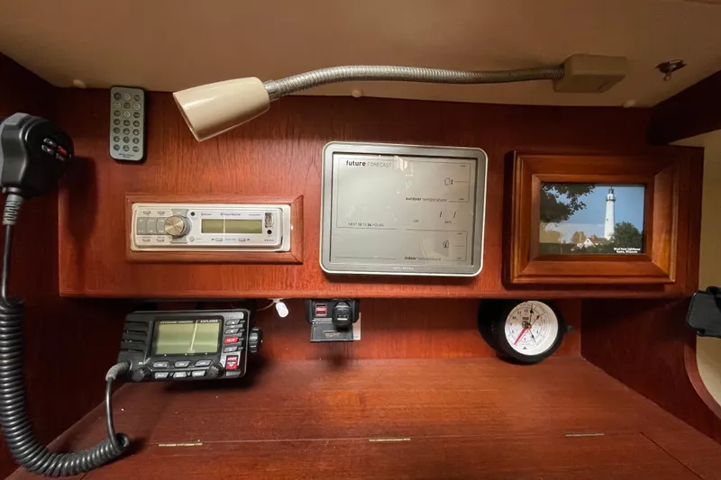 Slide: The Image of 1985 Canadian Sailcraft CS 30 interior with navigation equipment and framed lighthouse photo. - 20