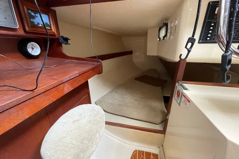Slide: The Image of 1985 Canadian Sailcraft CS 30 cabin interior with navigation desk and cozy sleeping area. - 23
