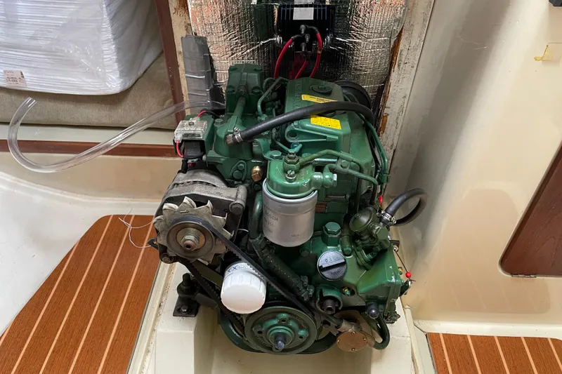 Slide: The Image of 1985 Canadian Sailcraft CS 30 engine compartment with visible green marine engine. - 30