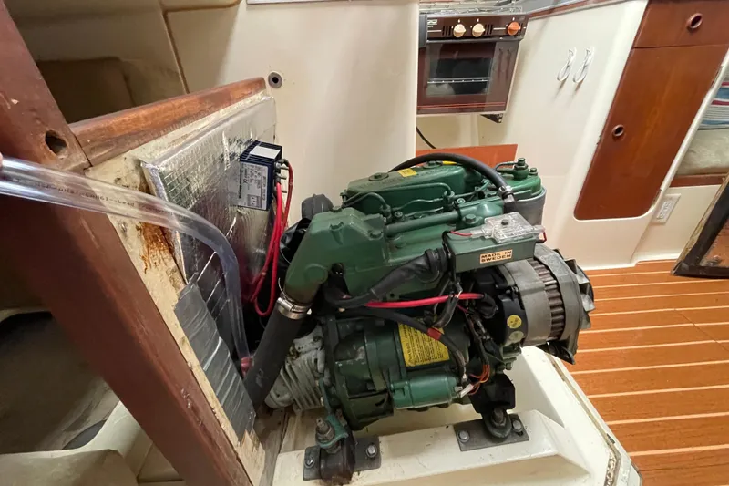 Slide: The Image of Engine compartment of 1985 Canadian Sailcraft CS 30 sailboat, featuring a green marine engine. - 31