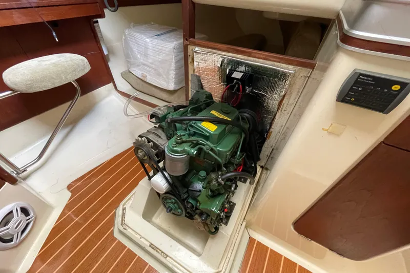 Slide: The Image of Engine compartment of a 1985 Canadian Sailcraft CS 30 sailboat, featuring a green engine. - 32