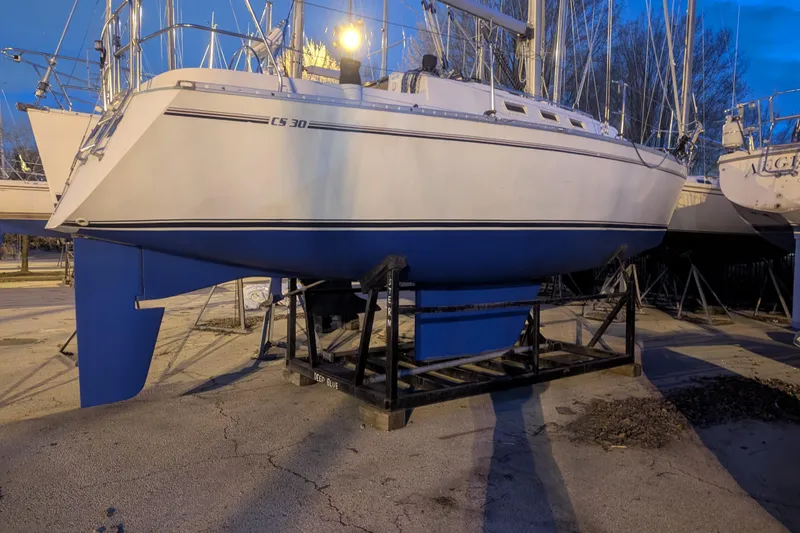 Slide: The Image of 1985 Canadian Sailcraft CS 30 sailboat on a stand, evening setting. - 34