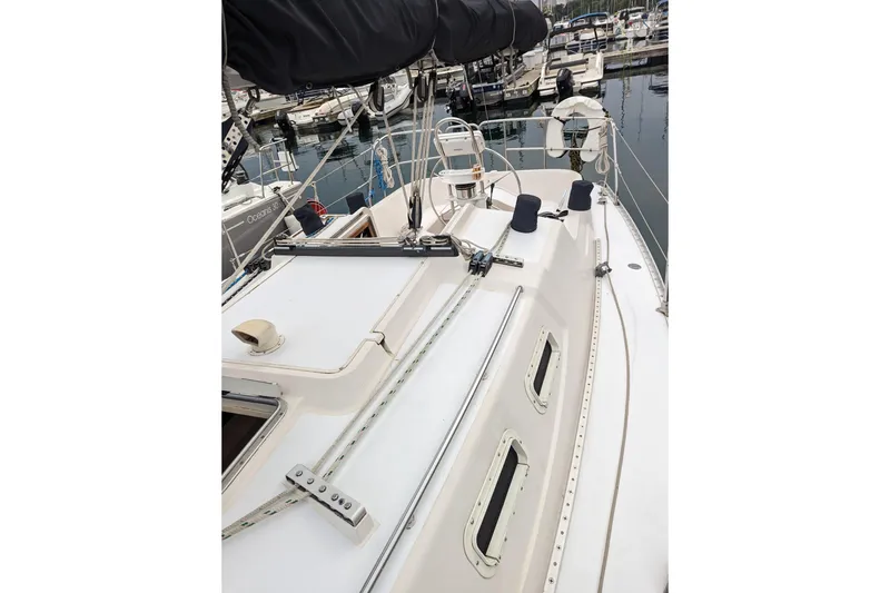 Slide: The Image of 1985 Canadian Sailcraft CS 30 sailboat docked at marina, showcasing deck and rigging. - 4