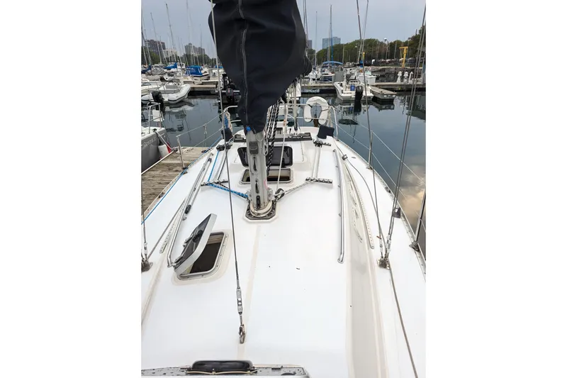 Slide: The Image of 1985 Canadian Sailcraft CS 30 sailboat docked in a marina, view of the deck and mast. - 7