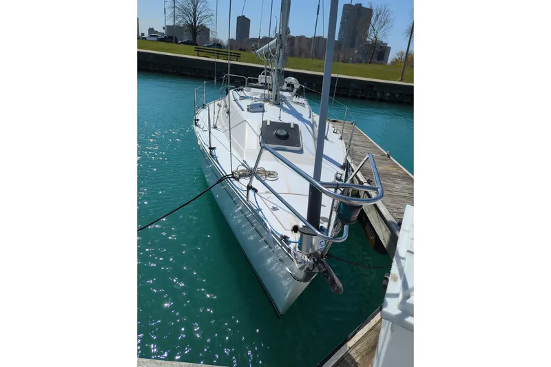 Slide: The Image of 1985 Canadian Sailcraft CS 30 sailboat docked in clear blue water. - 8