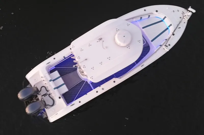 Slide: The Image of Aerial view of 2019 Cape Horn 27 boat with dual engines on dark water. - 10