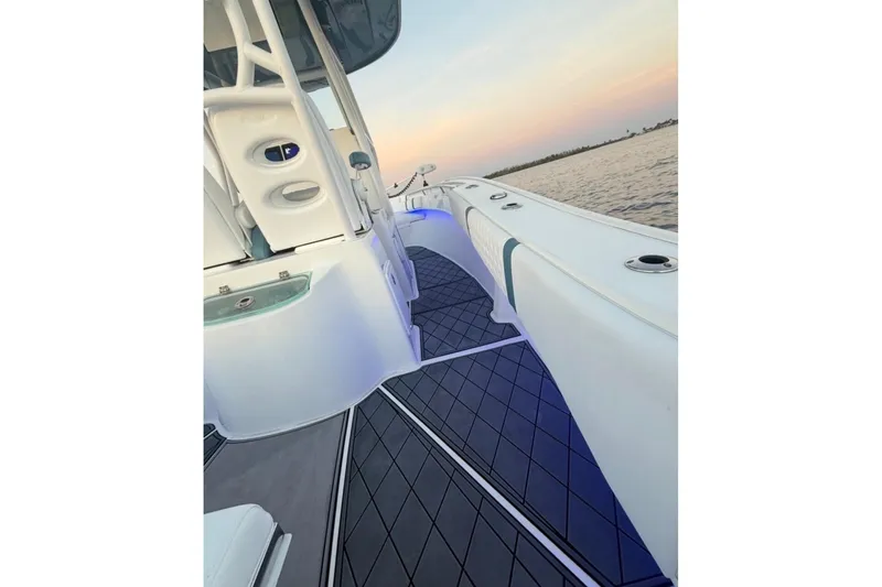 Slide: The Image of 2019 Cape Horn 27 boat interior with sleek design and ambient lighting at sunset. - 17