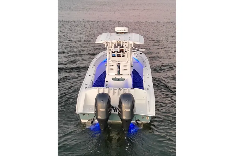 Slide: The Image of 2019 Cape Horn 27 boat with dual engines and blue deck lighting on water. - 20