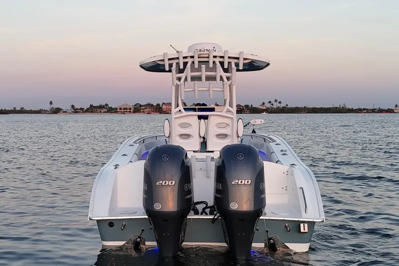 Slide: The Image of 2019 Cape Horn 27 boat with dual Yamaha 200 engines on calm water at sunset. - 23