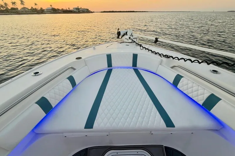 Slide: The Image of 2019 Cape Horn 27 boat interior with blue LED lighting at sunset on the water. - 36