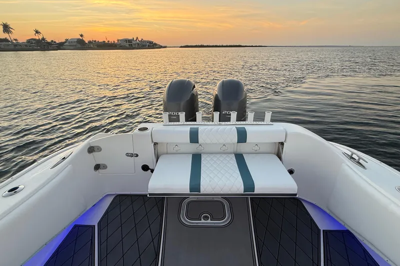 Slide: The Image of 2019 Cape Horn 27 boat at sunset, featuring dual engines and stylish seating. - 38