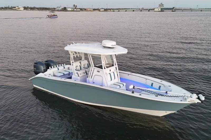 Slide: The Image of 2019 Cape Horn 27 boat on calm water, featuring dual engines and a sleek design. - 8