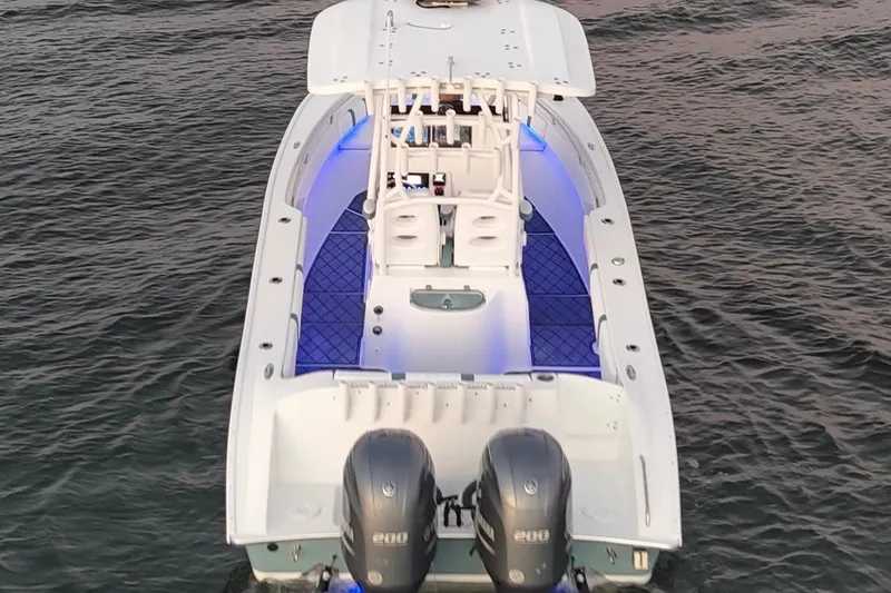Slide: The Image of 2019 Cape Horn 27 boat with dual engines, illuminated deck, on calm water. - 14