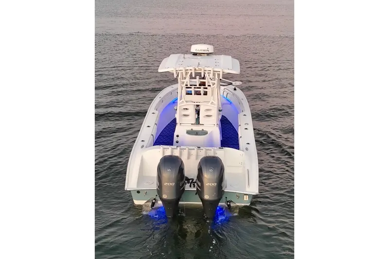 Slide: The Image of 2019 Cape Horn 27 boat with dual engines and blue deck lighting on water. - 15