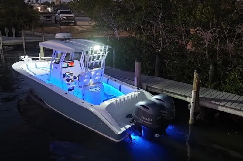 Slide: The Image of 2019 Cape Horn 27 boat with blue LED lights docked at night. - 19