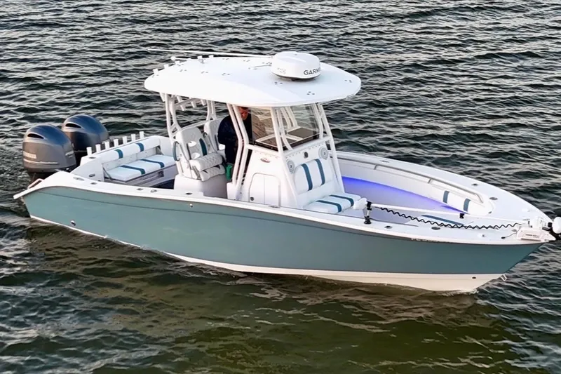 Slide: The Image of 2019 Cape Horn 27 boat on water, featuring dual engines and sleek design. - 2
