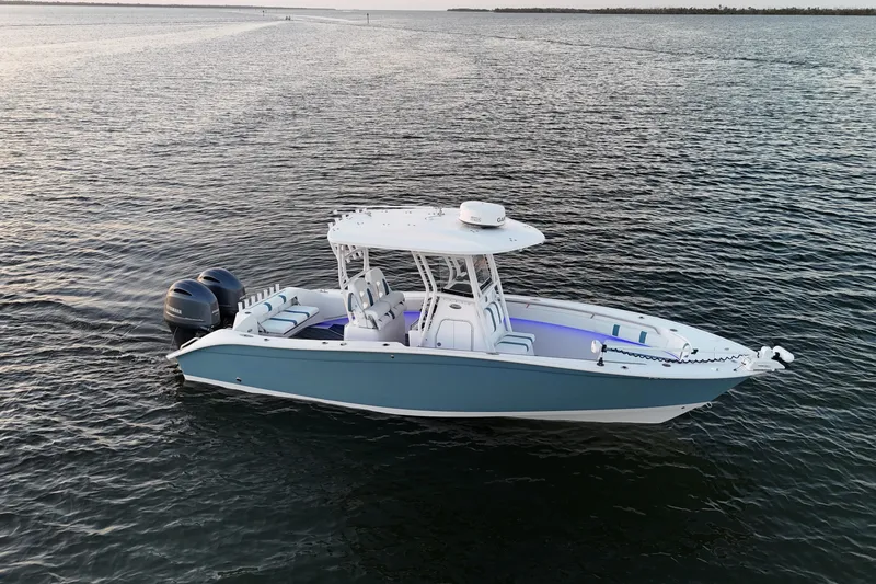 Slide: The Image of 2019 Cape Horn 27 boat on calm water, featuring dual engines and sleek design. - 21